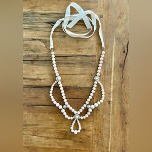 Long nude beaded necklace with cabochons and ribbon neck ties